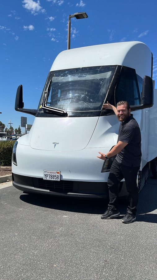 Patrick Mederos standing beside a Tesla Semi